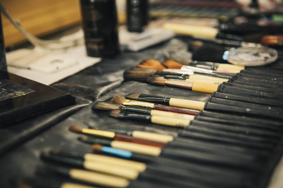 Multiple paintbrushes sit in a case for make-up courses